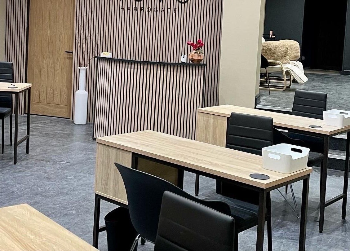 Modern interior of Novu Harrogate in Harrogate, England, GB, featuring sleek wooden tables and stylish decor.