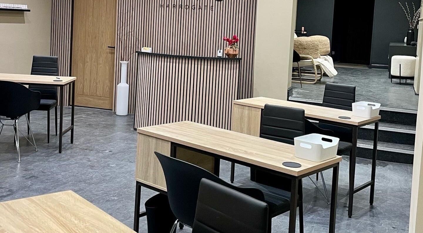 Modern interior of Novu Harrogate in Harrogate, England, GB, featuring sleek wooden tables and stylish decor.