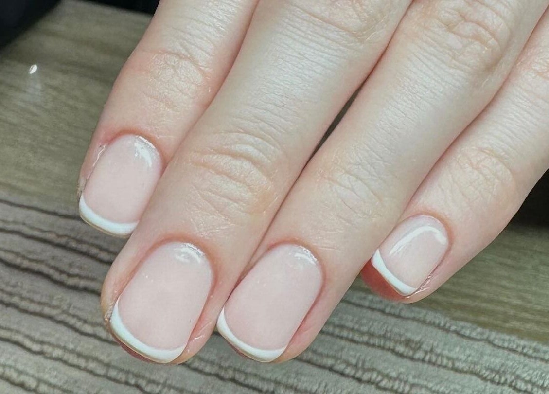 Close-up of elegant French manicure at Novu Harrogate, Harrogate, England, GB, showcasing refined nail art.