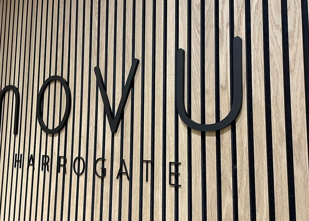 Elegant Novu Harrogate sign on a wooden wall in Harrogate, England, GB, showcasing luxury wellness.
