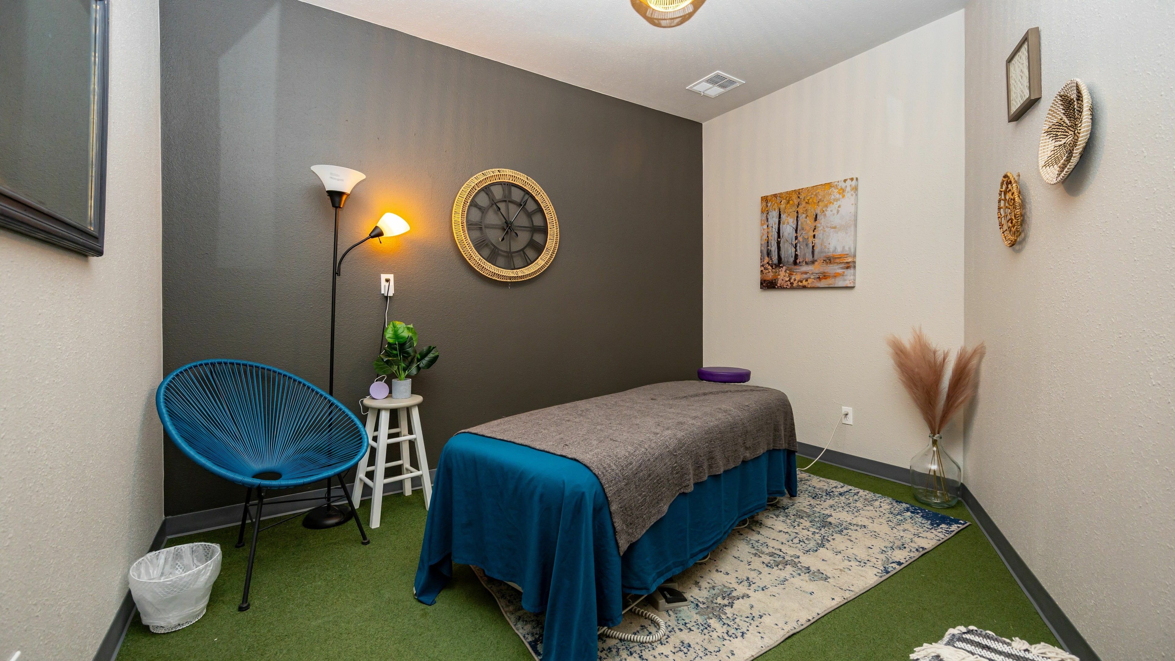 Relaxing massage room at Motion Massage- Wheat Ridge in Wheat Ridge, Colorado, US with ambient lighting and decor.