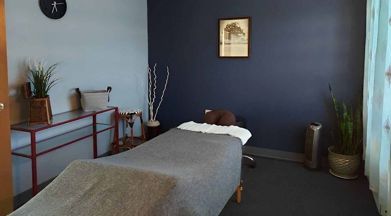 Tranquil massage room at Motion Massage Lakewood, Lakewood, Colorado, US with soft lighting and cozy decor.
