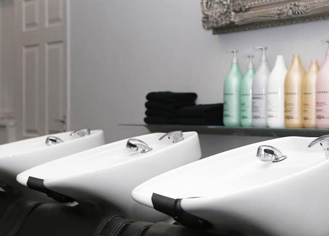 Elegant washbasins and products at Chair-Sam Slater, Birmingham, England, GB salon.