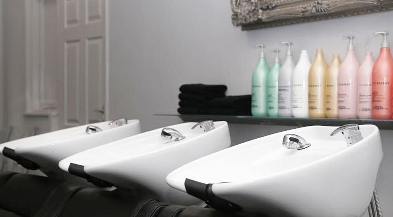 Elegant washbasins and products at Chair-Sam Slater, Birmingham, England, GB salon.