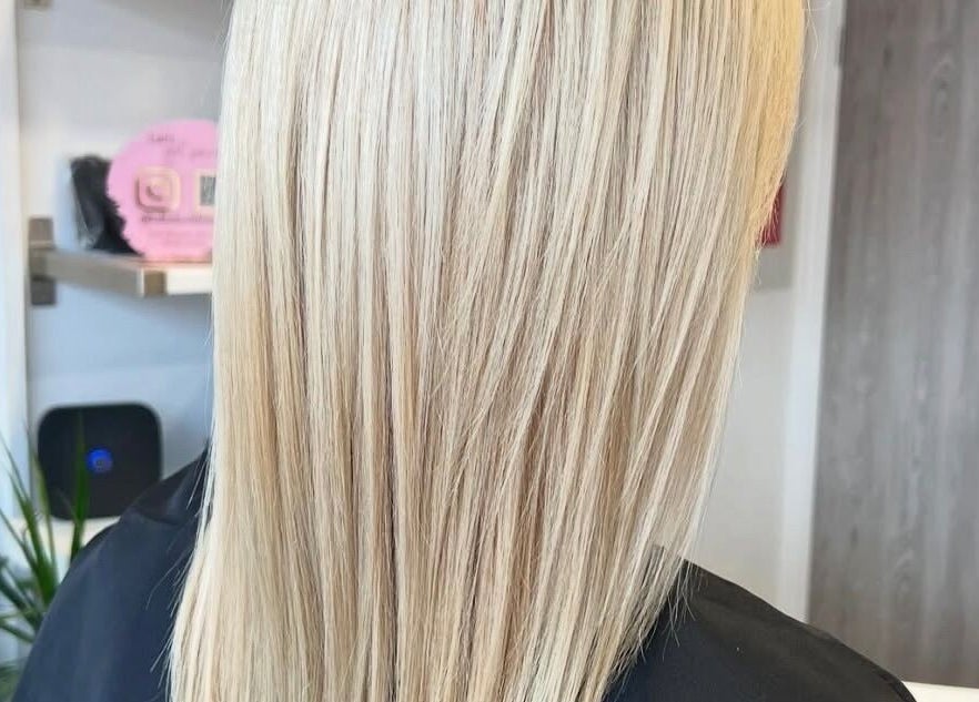 Sleek blonde hairstyle at Chair-Sam Slater, Birmingham, England, GB.