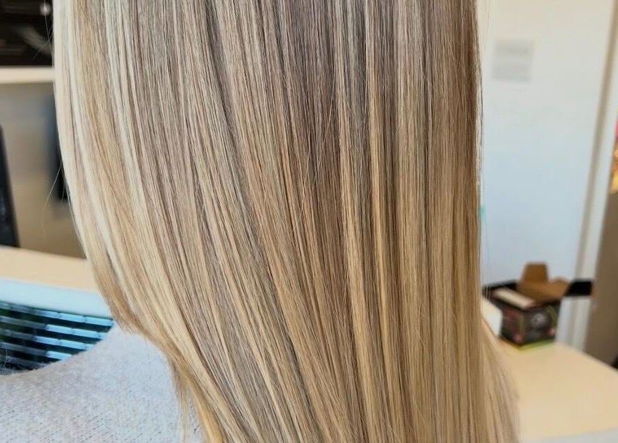 Sleek blonde hair styled at Chair-Sam Slater in Birmingham, England, GB, showcasing glossy highlights.
