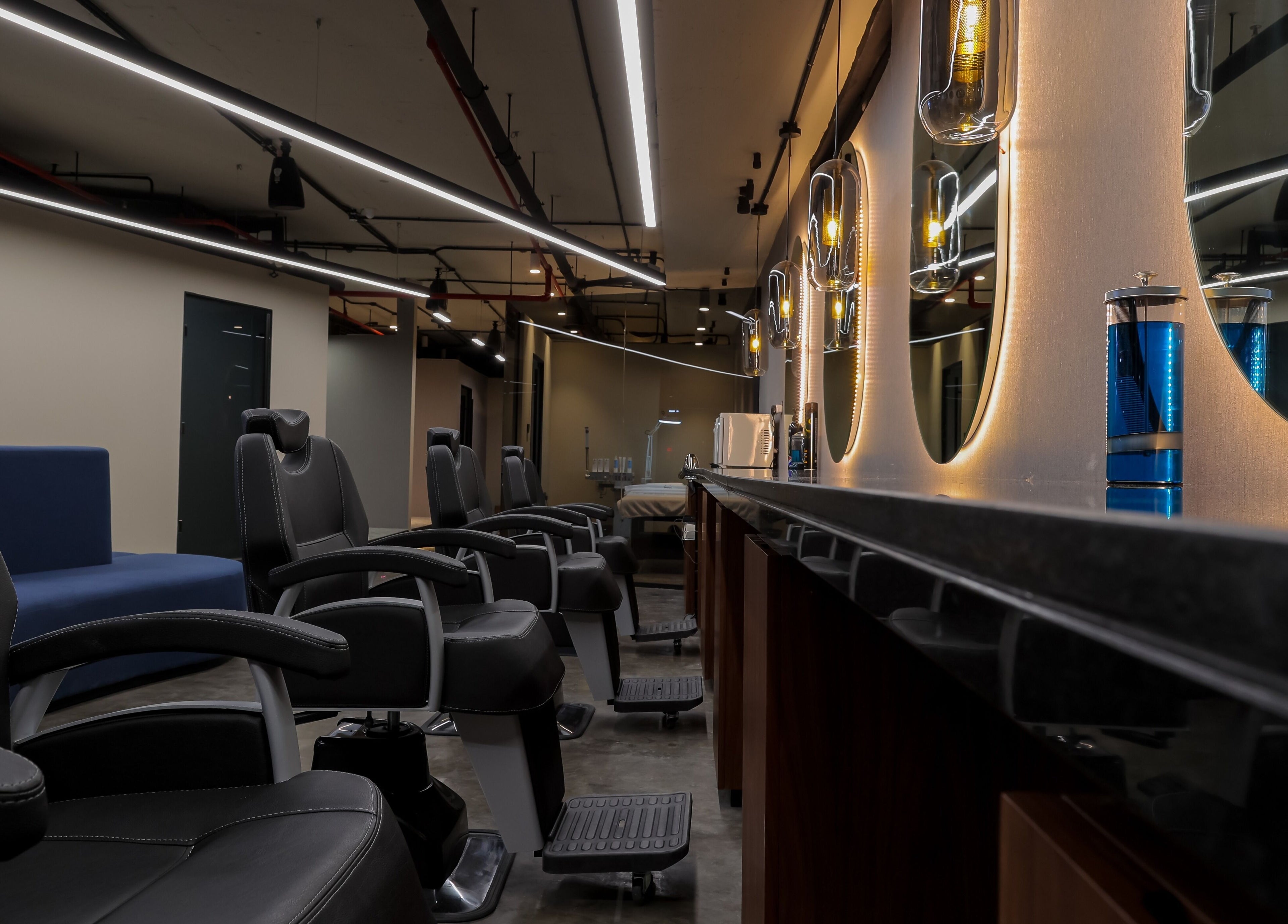 Chic salon interior at Hairpage, Saar BH with modern styling chairs and ambient lighting.