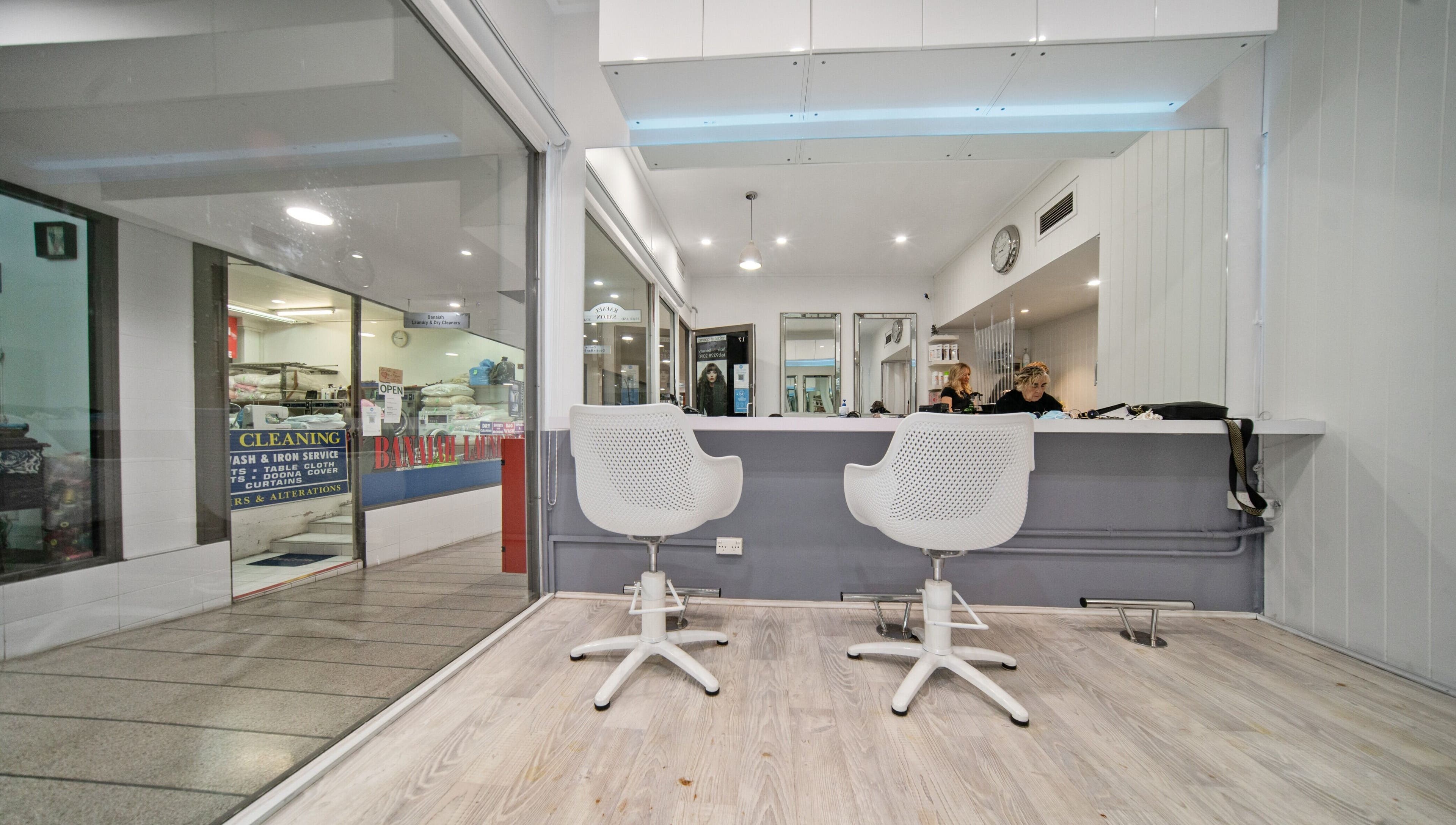Contemporary interior of Rafael Salon - Double Bay, featuring sleek chairs and mirrors. Located in Double Bay, NSW, AU.