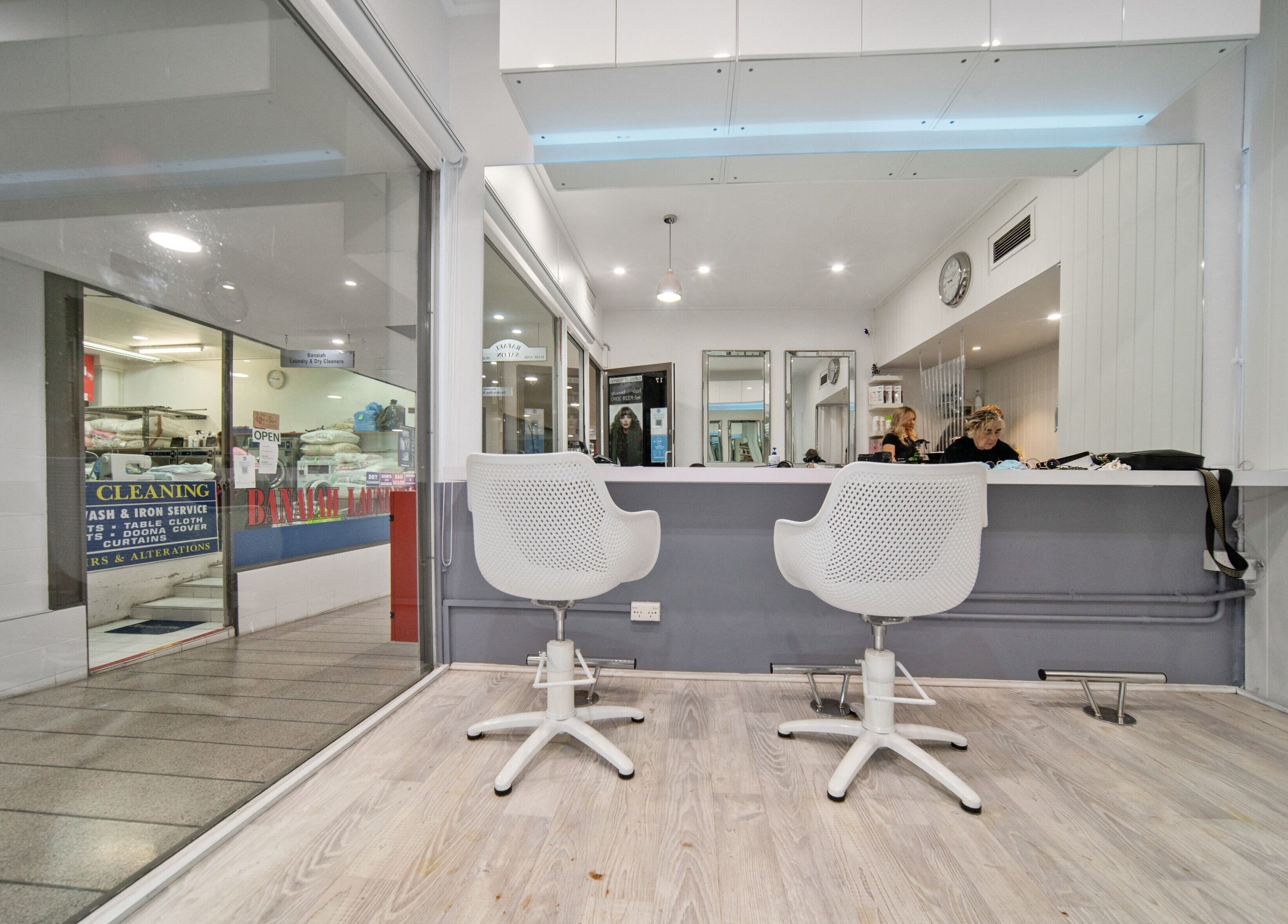 Contemporary interior of Rafael Salon - Double Bay, featuring sleek chairs and mirrors. Located in Double Bay, NSW, AU.
