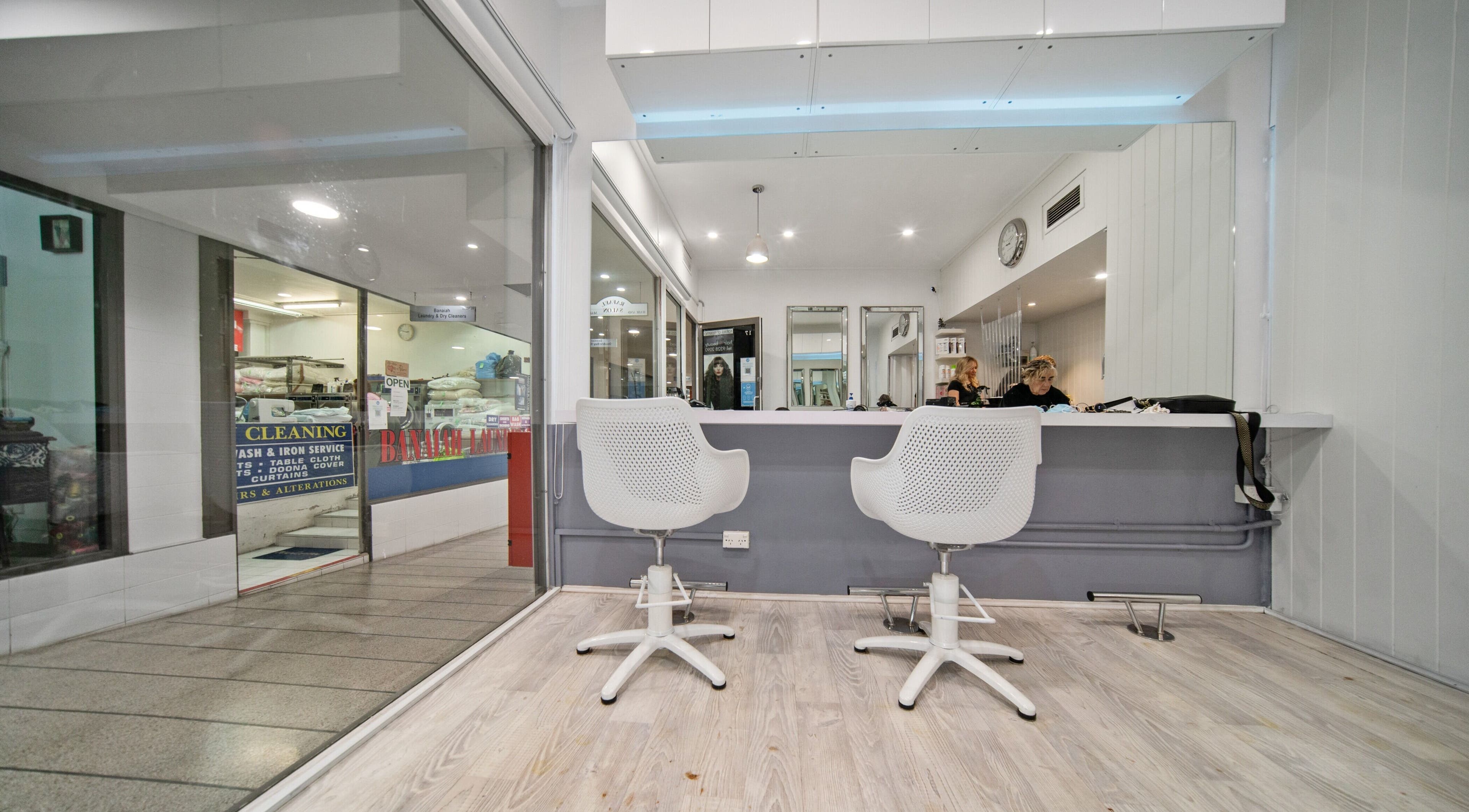 Contemporary interior of Rafael Salon - Double Bay, featuring sleek chairs and mirrors. Located in Double Bay, NSW, AU.