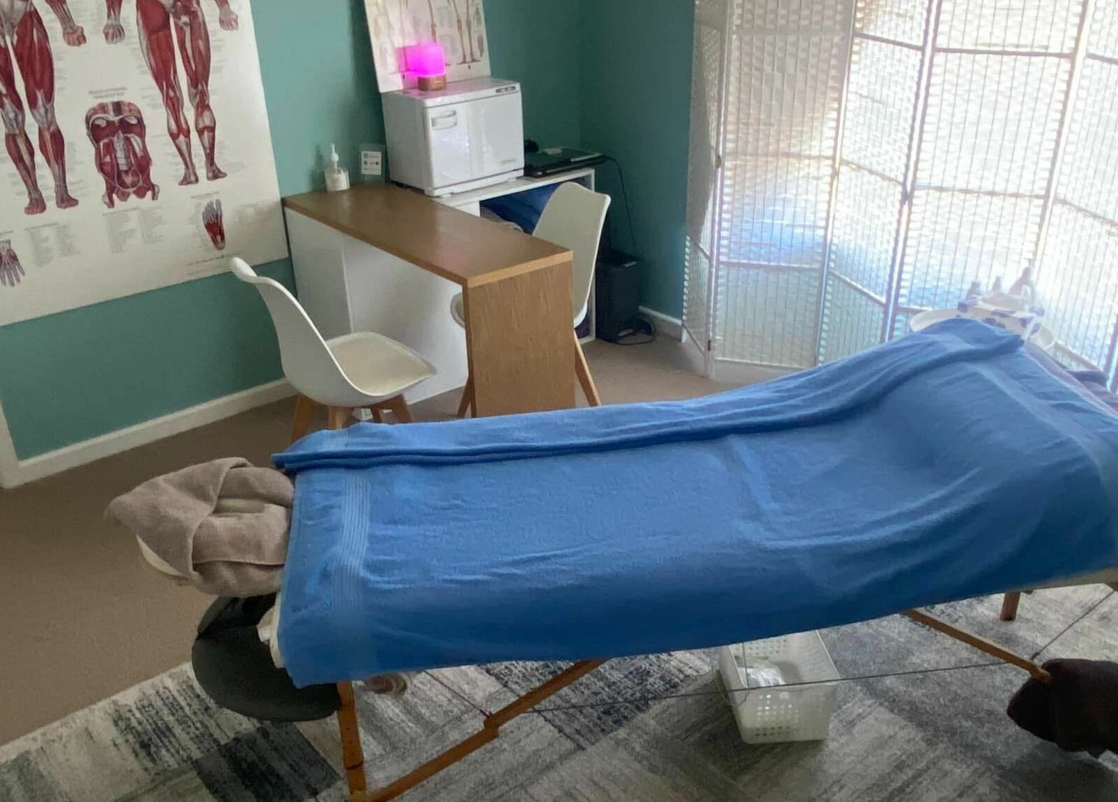 Cozy massage room at The Massage Shed, Wodonga, Victoria, AU with treatment table and calming decor.