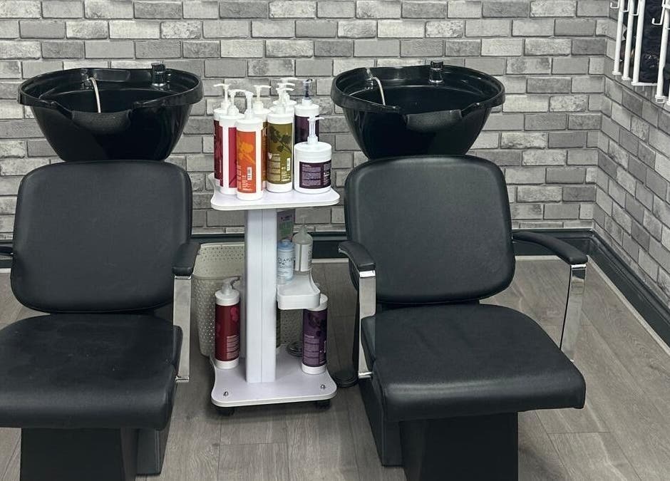 Stylish wash station at All in One Worcester salon, Worcester, England, GB. Features dual chairs and modern decor.