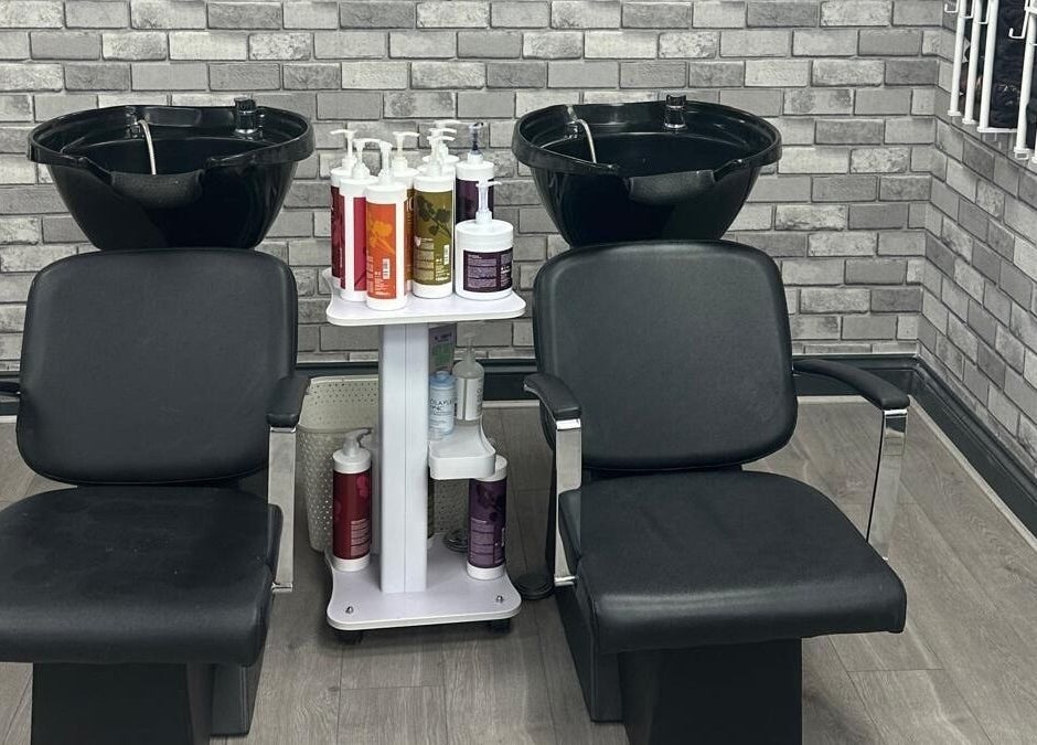 Stylish wash station at All in One Worcester salon, Worcester, England, GB. Features dual chairs and modern decor.
