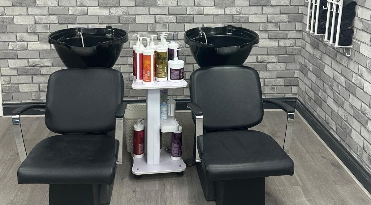 Stylish wash station at All in One Worcester salon, Worcester, England, GB. Features dual chairs and modern decor.
