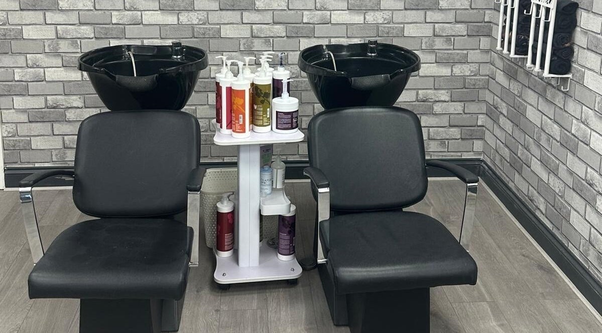 Stylish wash station at All in One Worcester salon, Worcester, England, GB. Features dual chairs and modern decor.