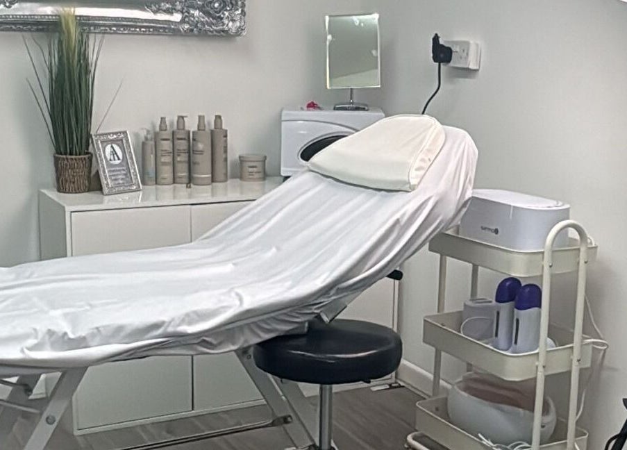 Sleek treatment room at All in One Worcester, Worcester, England, GB, featuring a modern spa bed and decor.