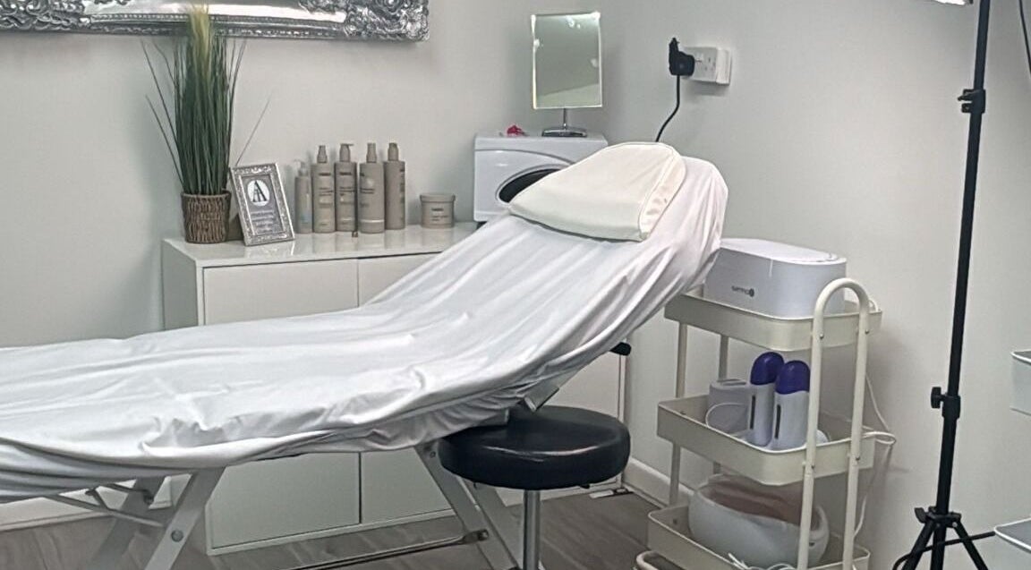 Sleek treatment room at All in One Worcester, Worcester, England, GB, featuring a modern spa bed and decor.