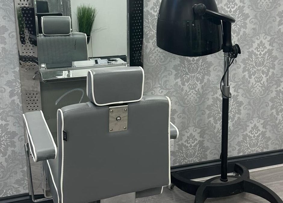 Modern salon station at All in One Worcester, Worcester, England, GB with sleek chair and dryer.