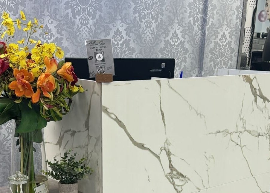 Reception desk with floral arrangement at All in One Worcester, Worcester, England, GB.