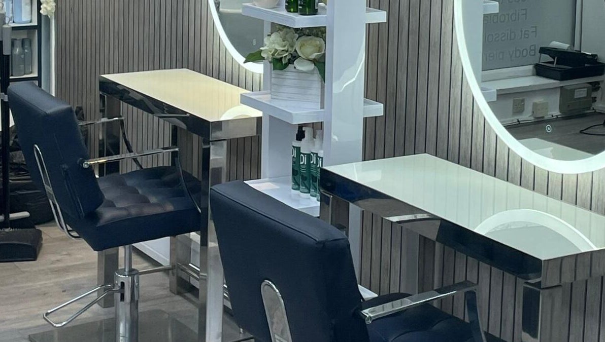 Chic beauty stations at All in One (Droitwich) in Droitwich Spa, England, GB with stylish chairs and mirrors.