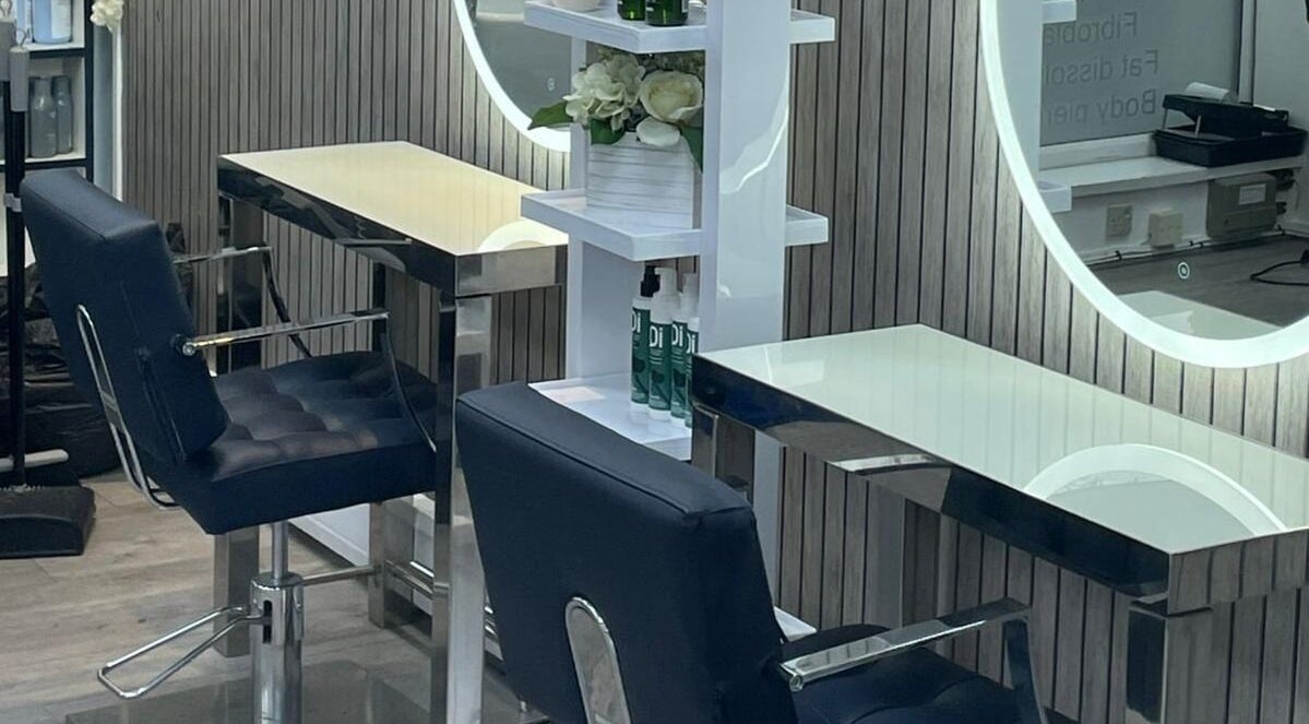 Chic beauty stations at All in One (Droitwich) in Droitwich Spa, England, GB with stylish chairs and mirrors.