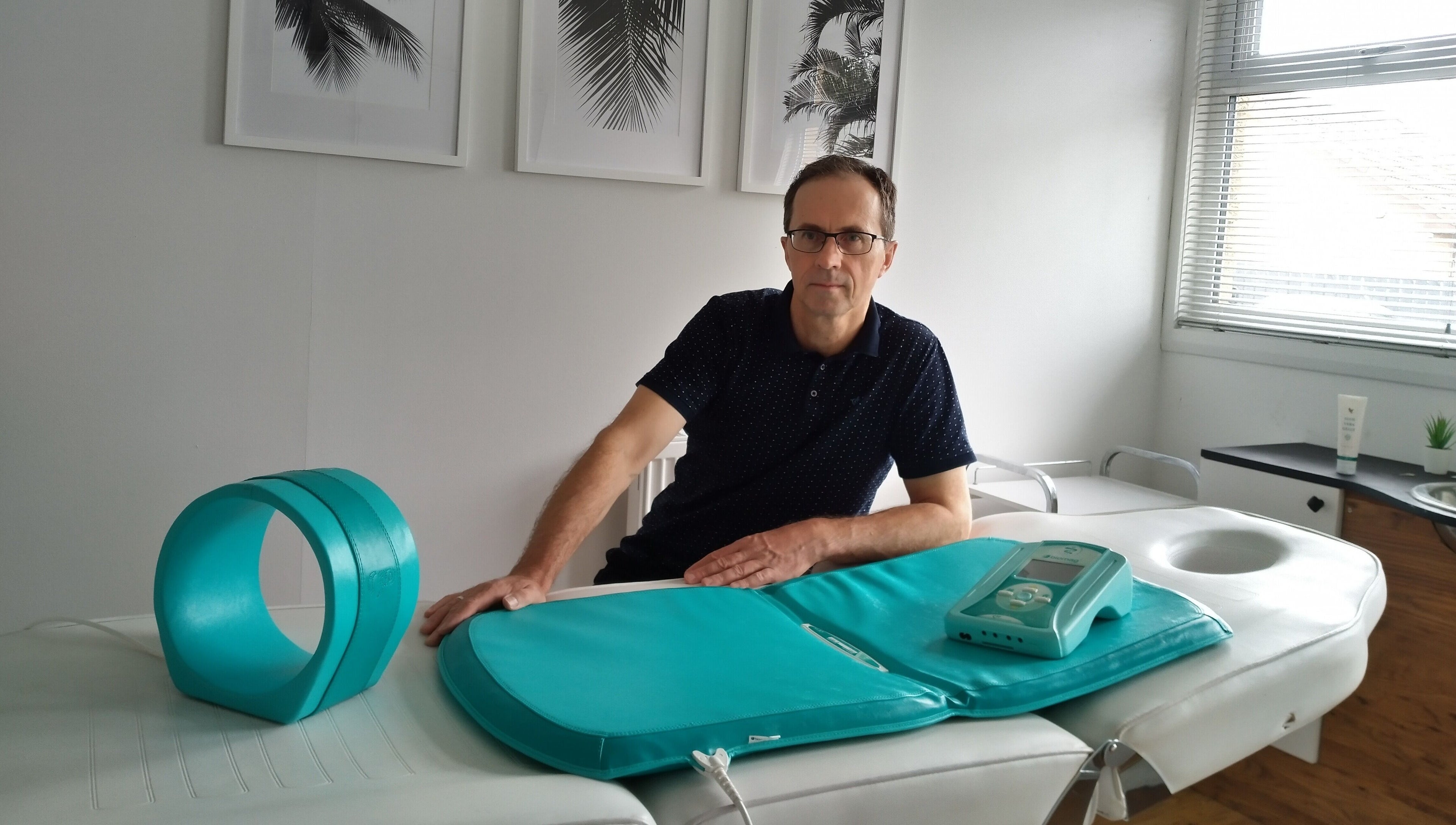 Therapist and equipment in serene room at Lothian Massage & Acupuncture, Tranent, Scotland, GB.