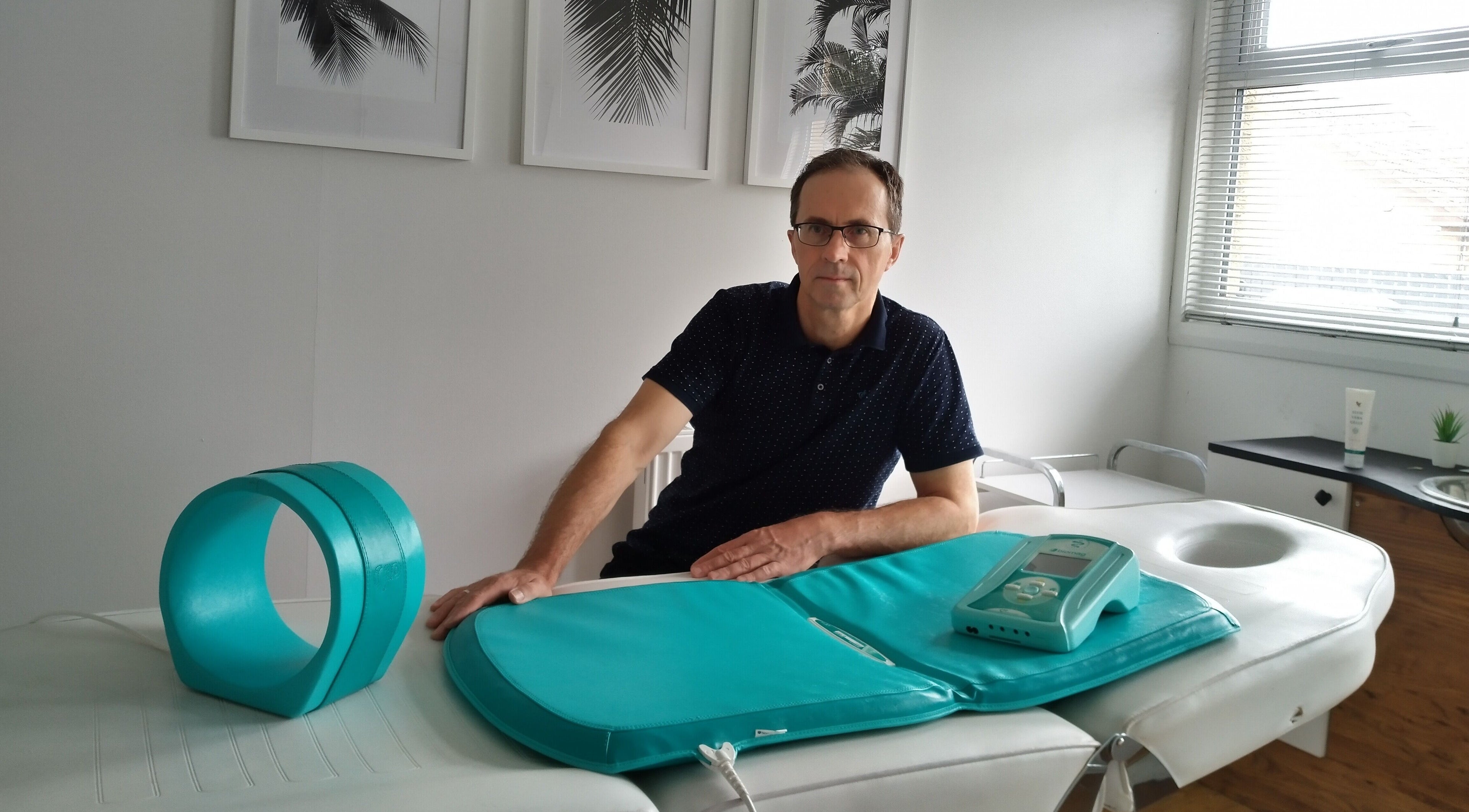 Therapist and equipment in serene room at Lothian Massage & Acupuncture, Tranent, Scotland, GB.