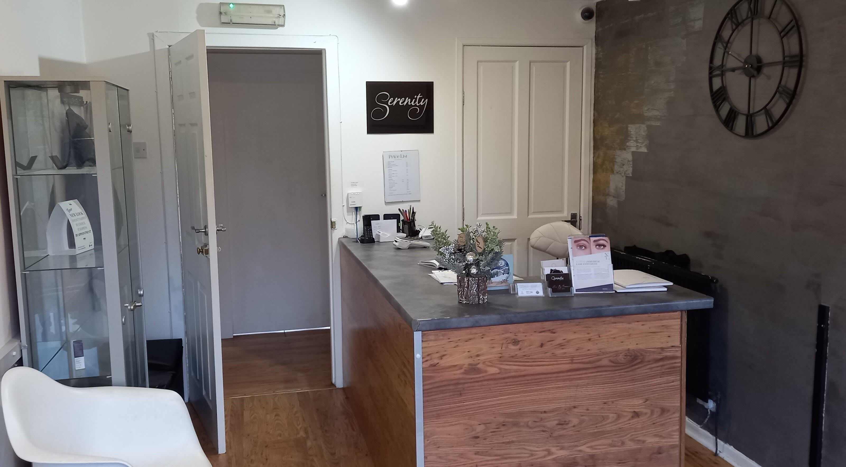 Reception area at Lothian Massage & Acupuncture, Tranent, Scotland, GB with a wooden desk and decor.