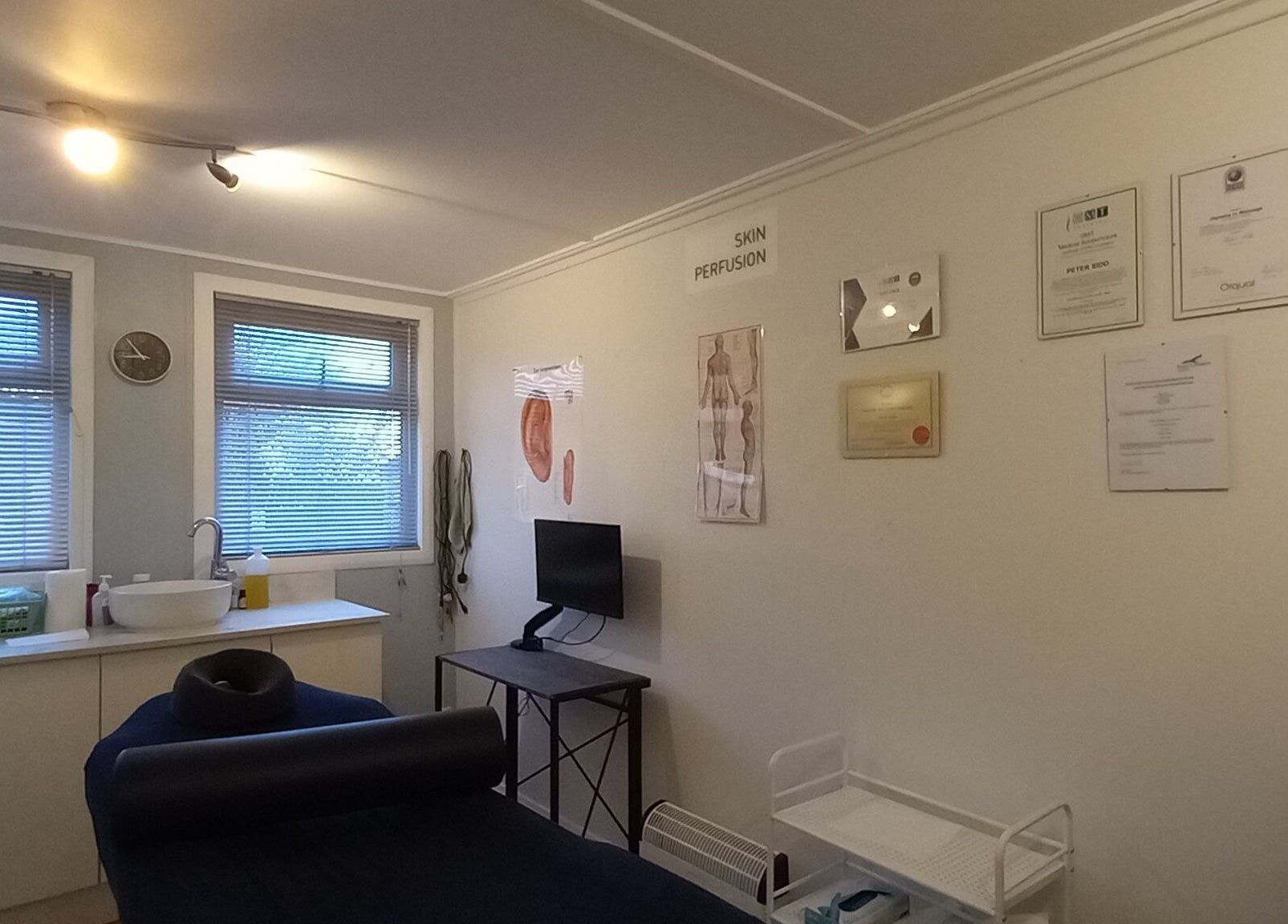 Relaxing massage room at Lothian Massage & Acupuncture, Tranent, Scotland, GB. Cozy ambiance with certificates on display.