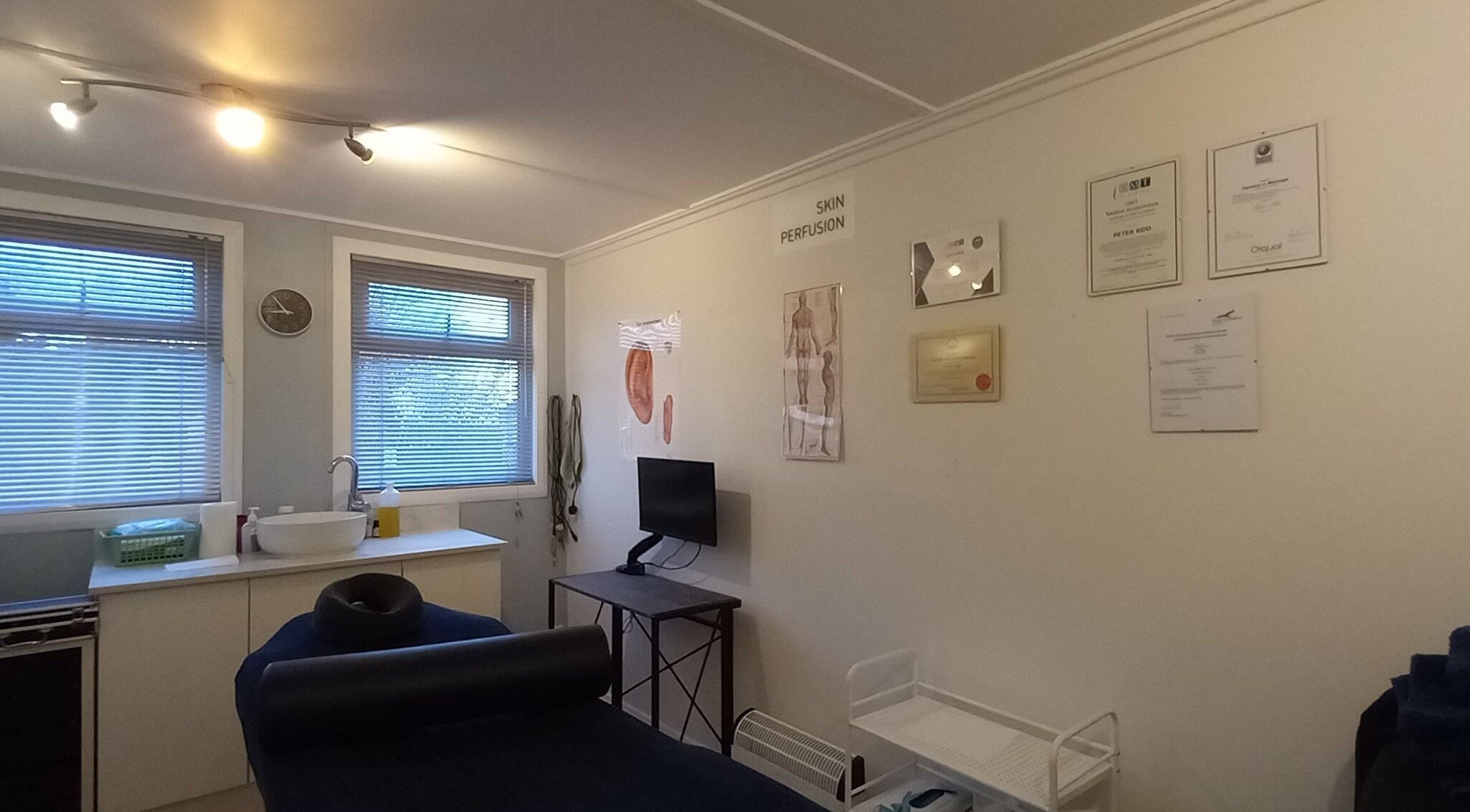 Relaxing massage room at Lothian Massage & Acupuncture, Tranent, Scotland, GB. Cozy ambiance with certificates on display.