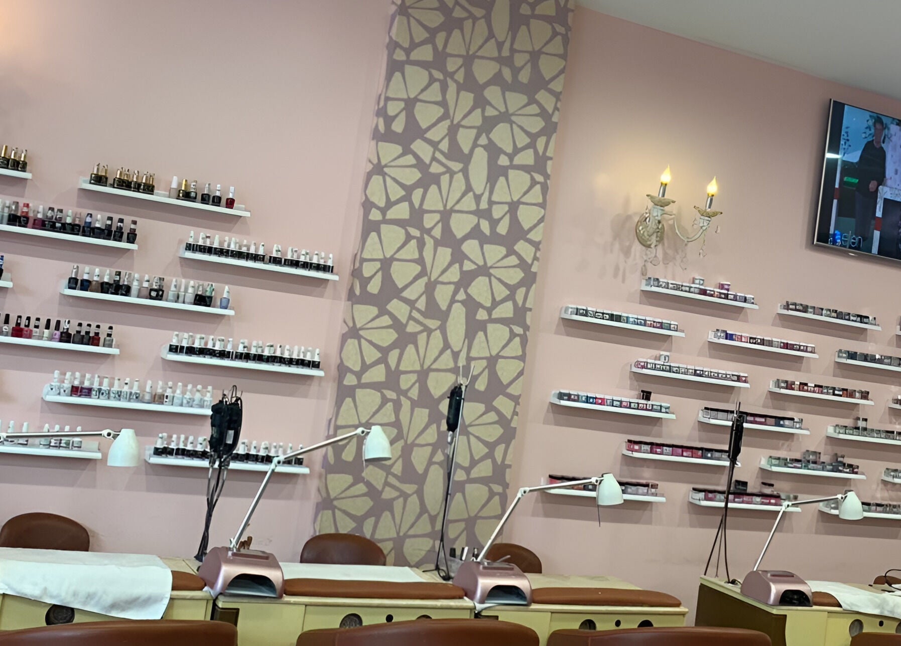 Coco Nails interior with polish displays, lamp-lit stations in Melbourne, Victoria, AU.