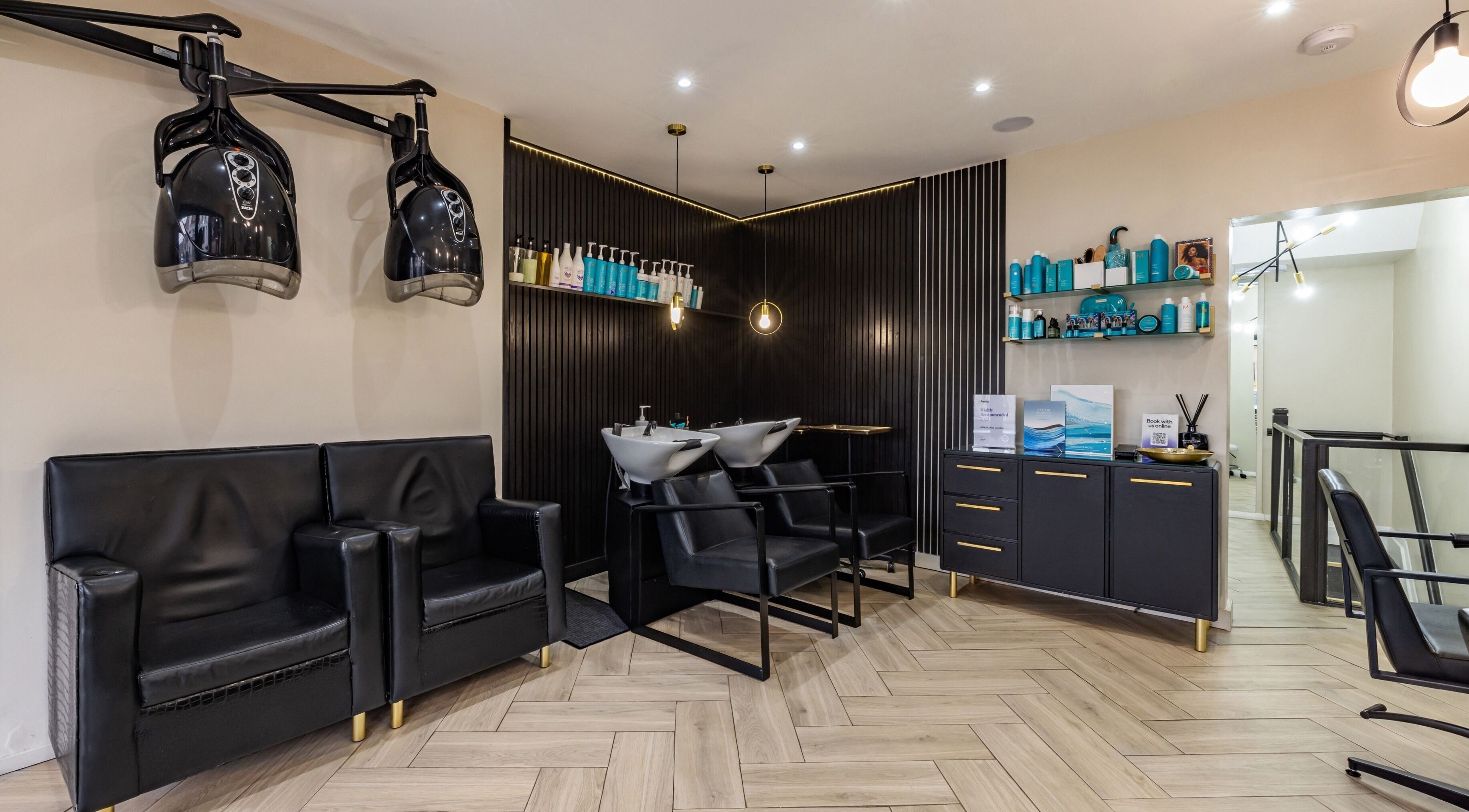 Sophisticated salon interior with modern chairs at ATH Studios, Croydon, England, GB.