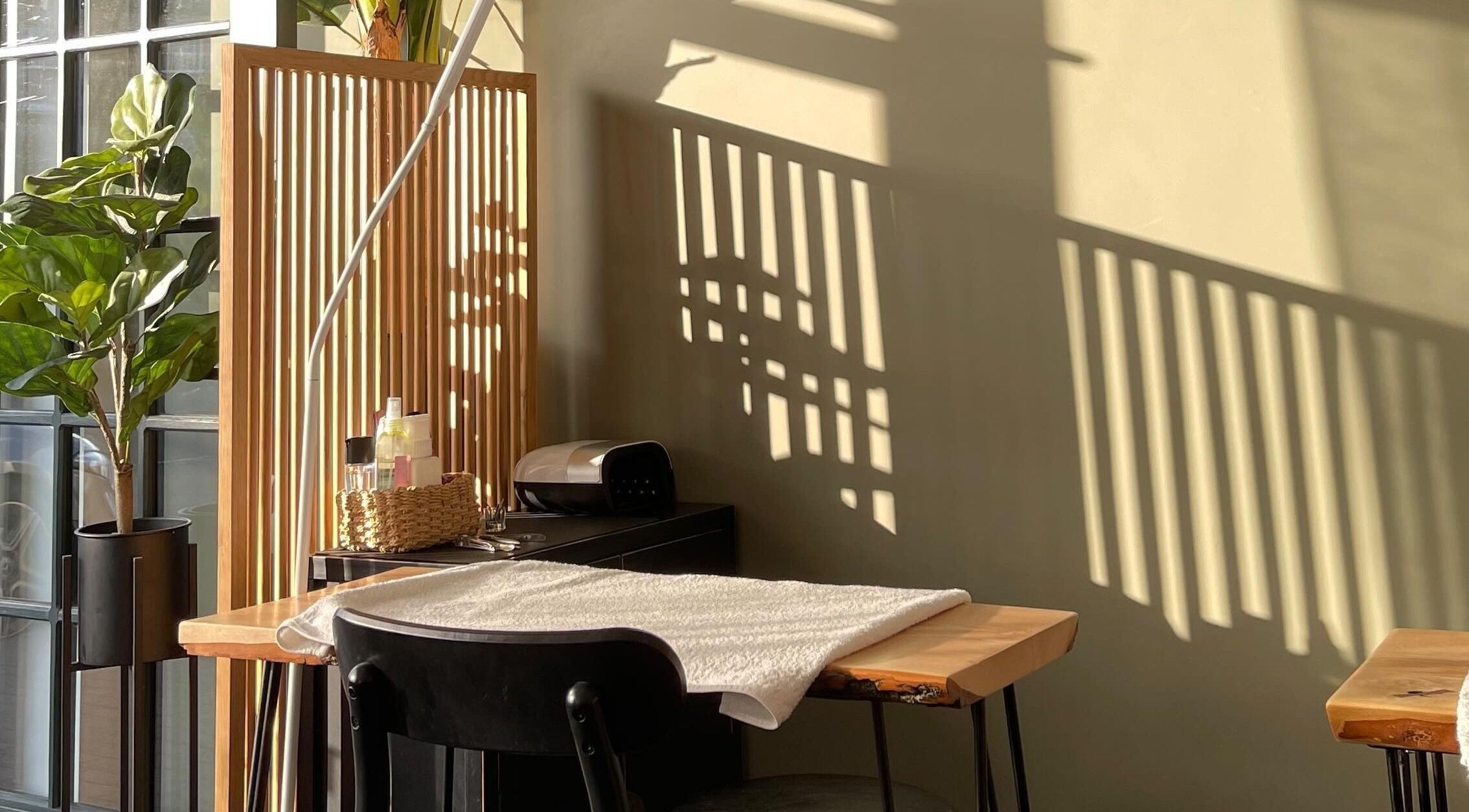 Sunlit wellness space at Aesthetica, Bishopbriggs, Scotland, GB, featuring a serene massage setup.