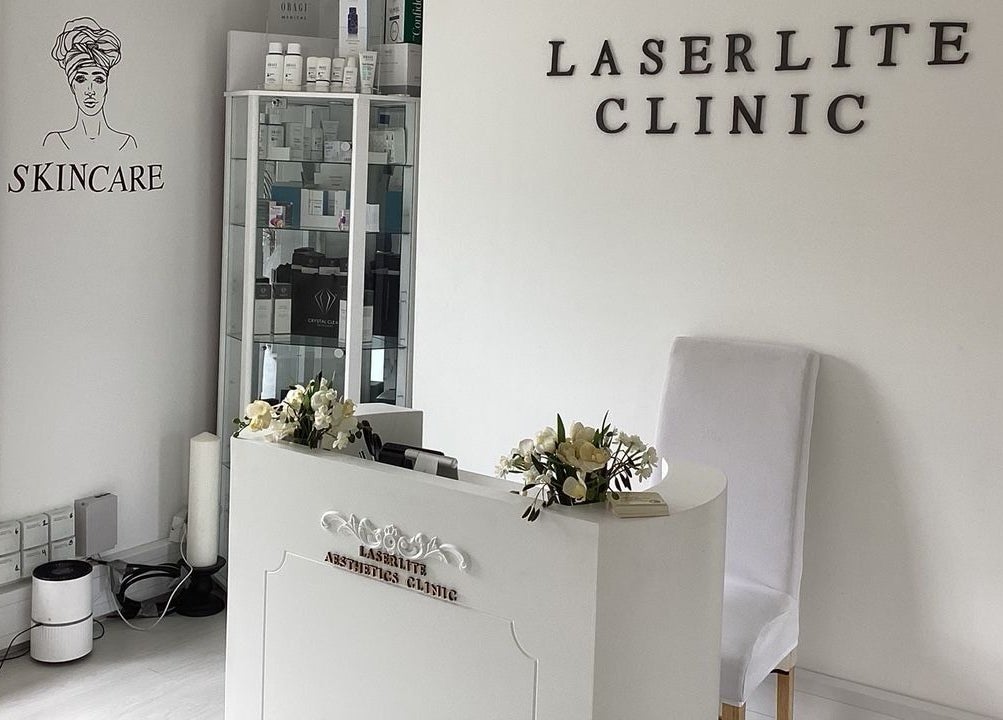 Reception area of Laserlite Aesthetic Clinic, Croydon, England, GB with skincare products displayed.