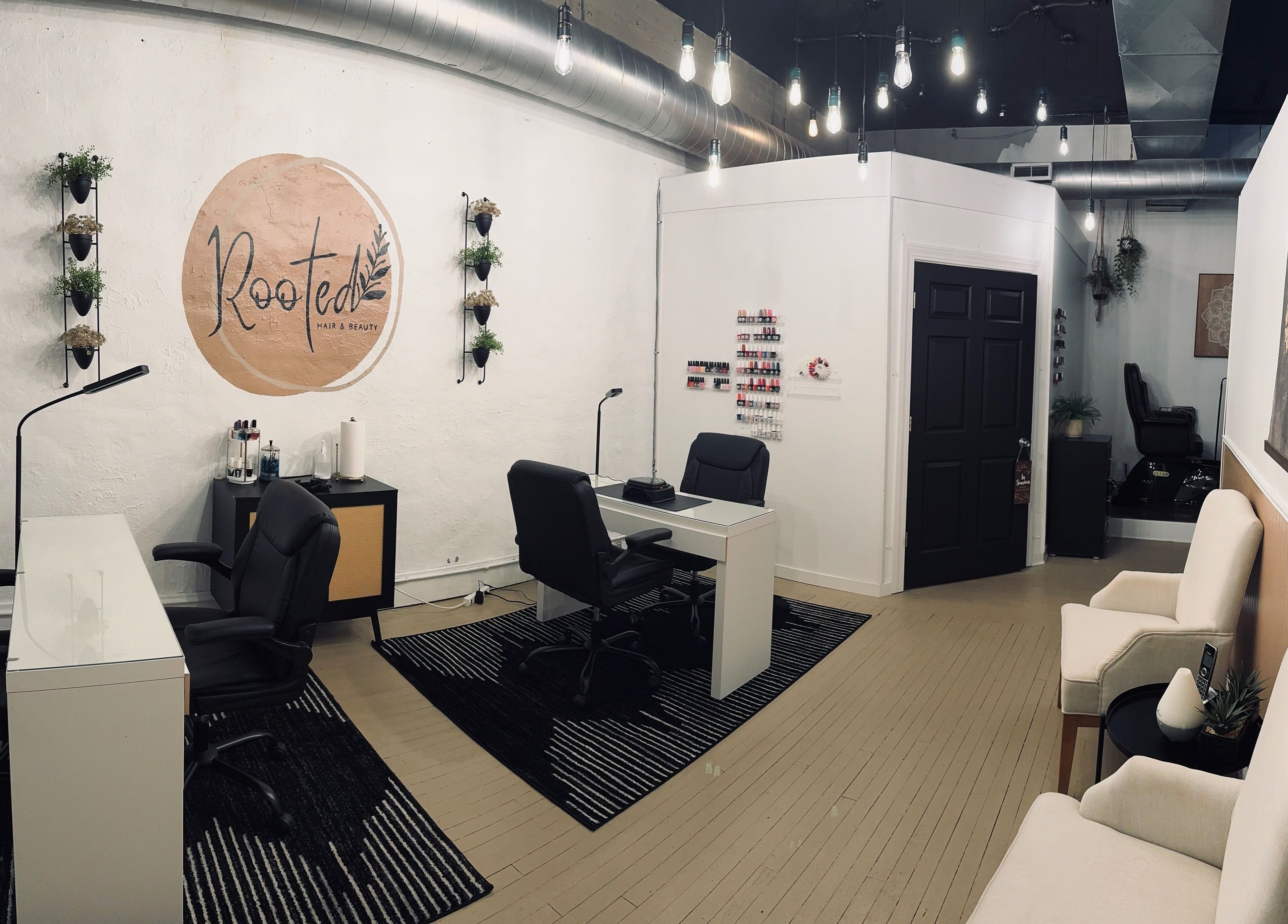 Elegant interior of Rooted Salon in Eaton Rapids, Michigan, US with modern decor and nail stations.