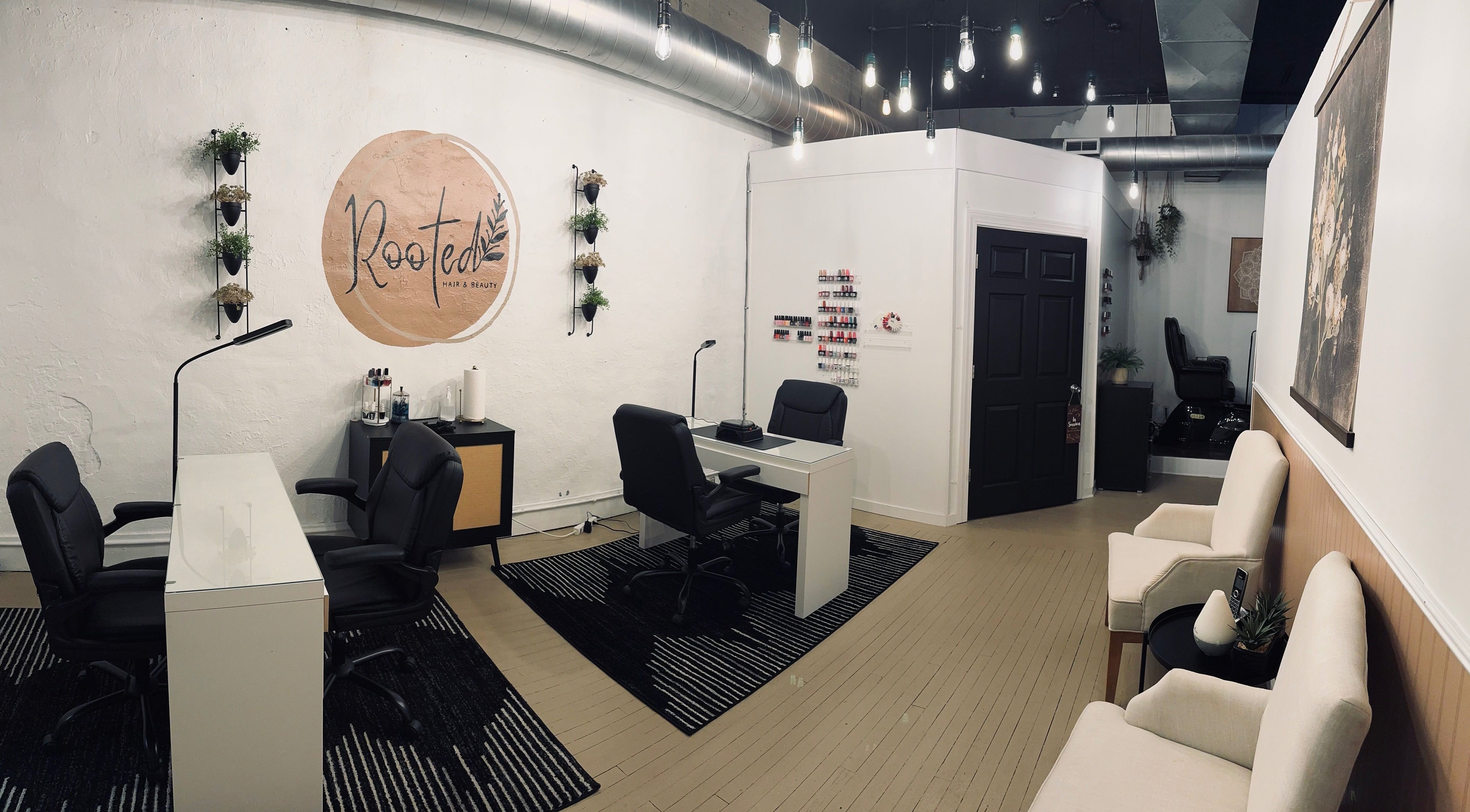 Elegant interior of Rooted Salon in Eaton Rapids, Michigan, US with modern decor and nail stations.