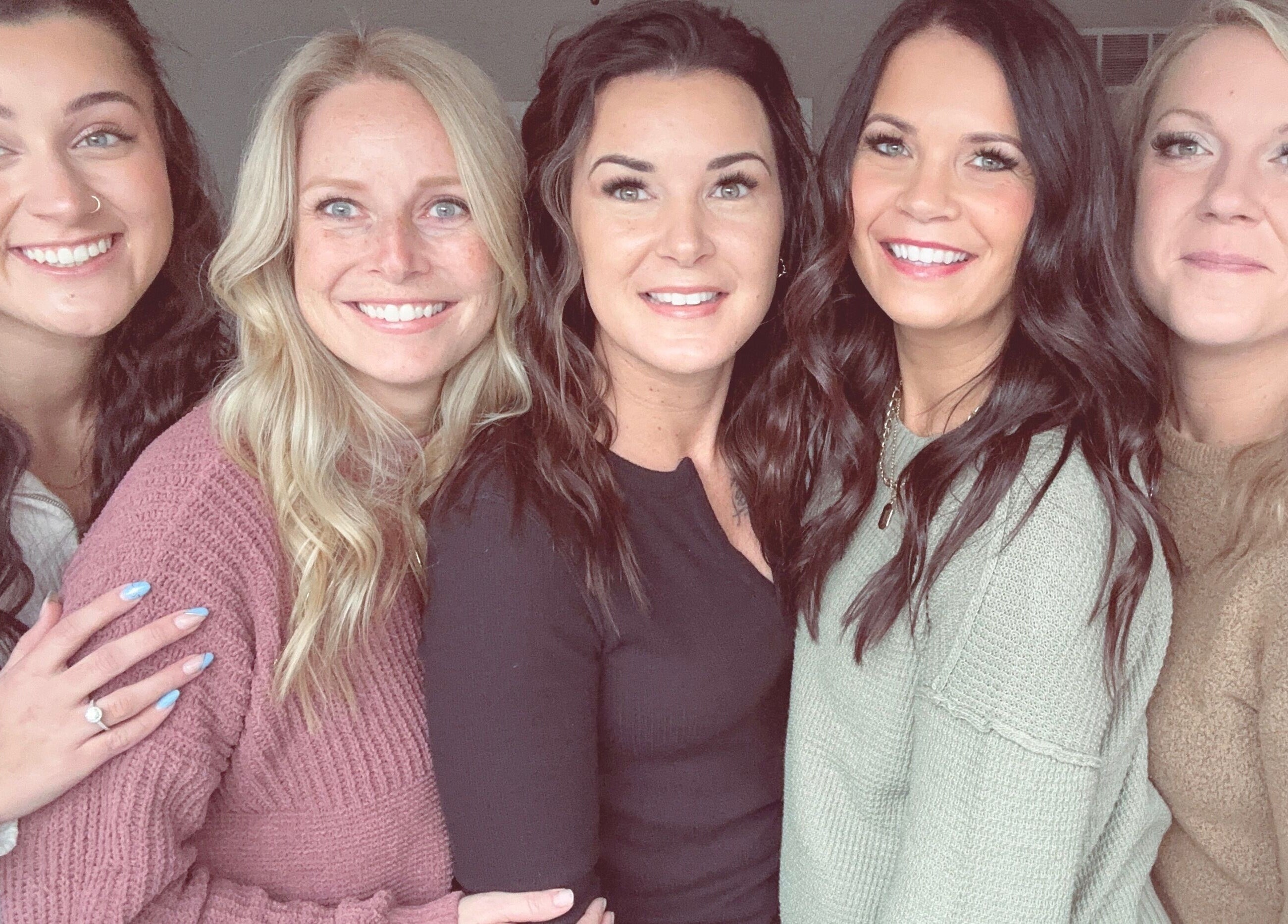 Smiling staff at Rooted Salon in Eaton Rapids, Michigan, US, showcasing welcoming salon atmosphere.