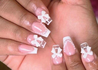 Detailed nail art with white bows at Chloe Studio Nail by Sophie, Garden Grove, California, US.
