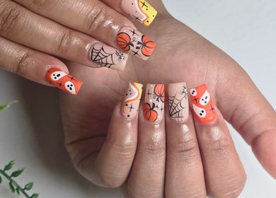 Halloween-themed nail art at Chloe Studio Nail by Sophie, Garden Grove, California, US, features pumpkins and ghosts.