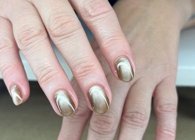 Elegant manicure at QWN Esther Beauty Bar, Willemstad, Curaçao, CW showcasing metallic nail art.