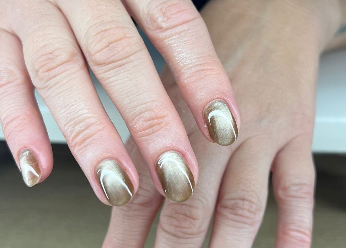 Elegant gold manicure at QWN Esther Beauty Bar in Willemstad, Curaçao, CW, showcasing exquisite nail artistry.