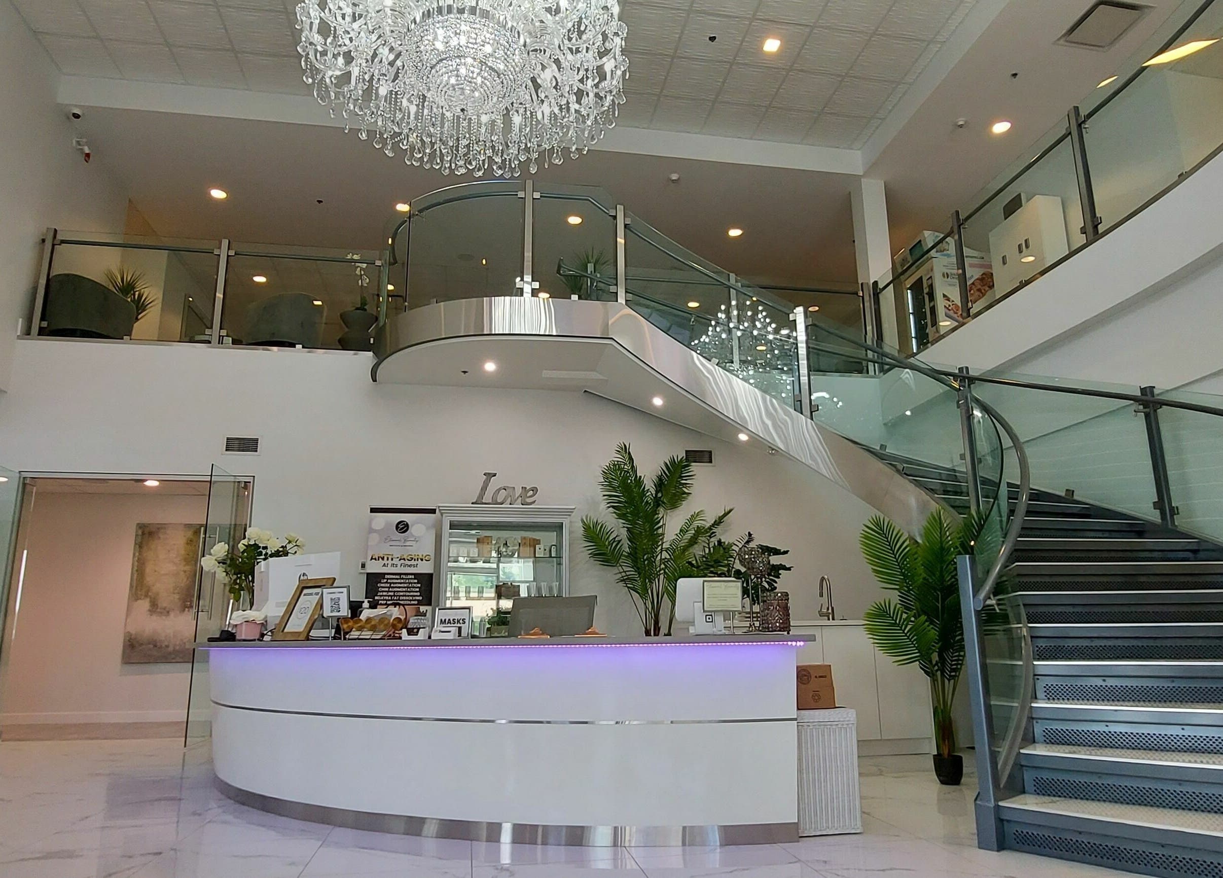 Luxurious modern entrance at K-BTS Main Shop, Calgary, Alberta, CA featuring chic decor and grand staircase.