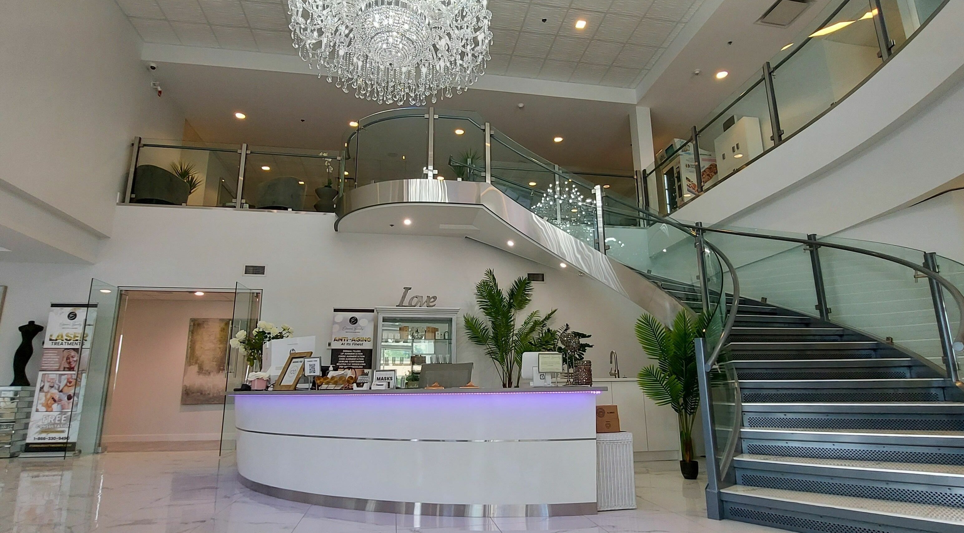 Luxurious modern entrance at K-BTS Main Shop, Calgary, Alberta, CA featuring chic decor and grand staircase.