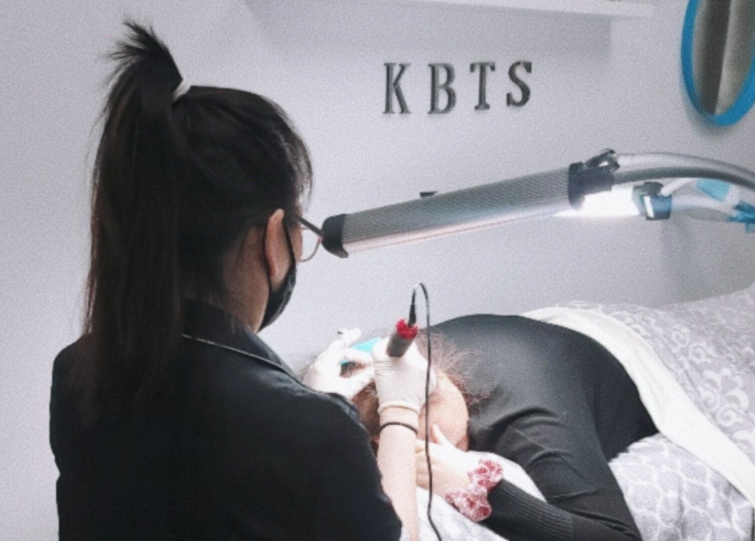 Expert providing facial treatment at K-BTS Main Shop in Calgary, Alberta, CA, enhancing beauty and wellness.