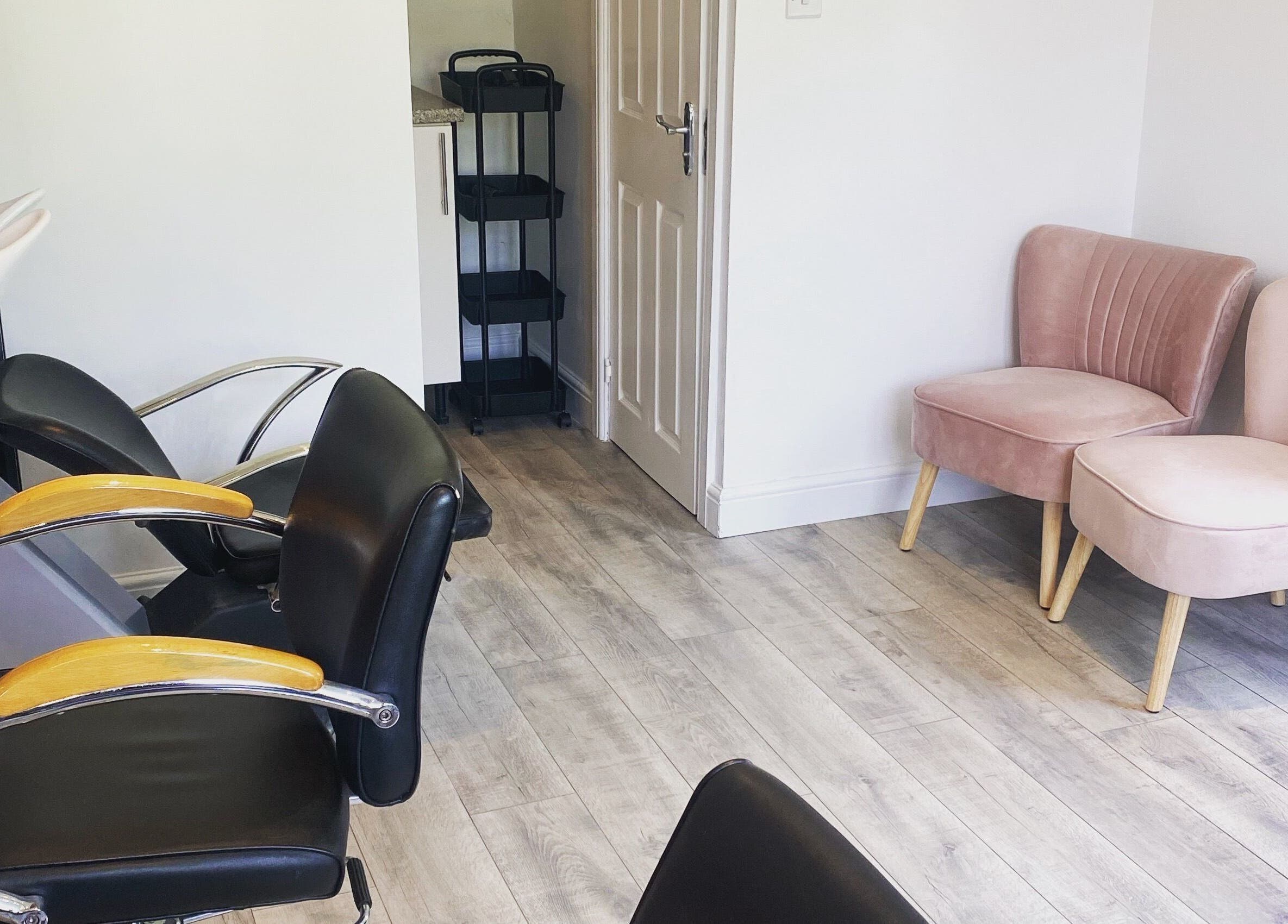 Modern seating area at The Salon at No.3 in Gloucester, England, GB with chairs and hair wash station.