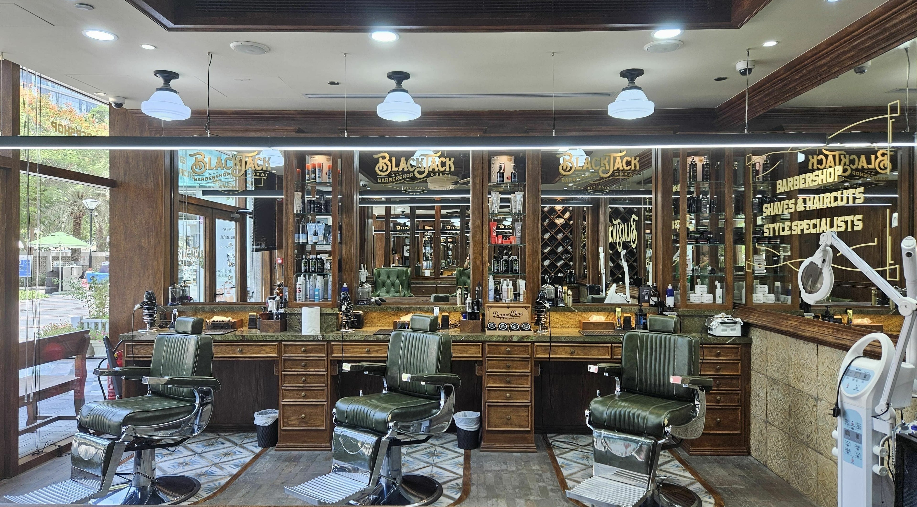 Interior of Business Avenue BlackJack Barbershop, Dubai, featuring classic barber chairs and mirrors.