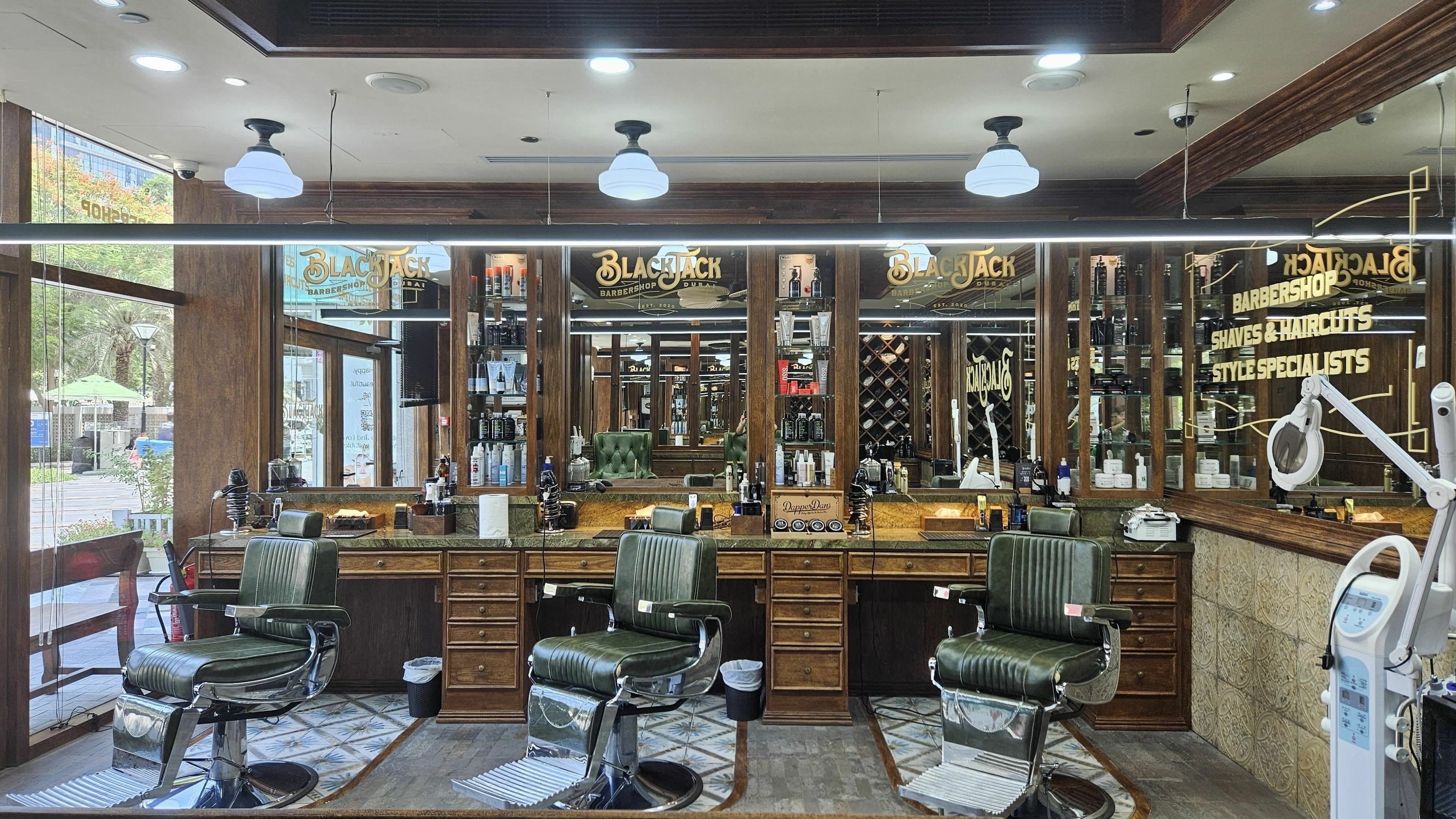 Interior of Business Avenue BlackJack Barbershop, Dubai, featuring classic barber chairs and mirrors.