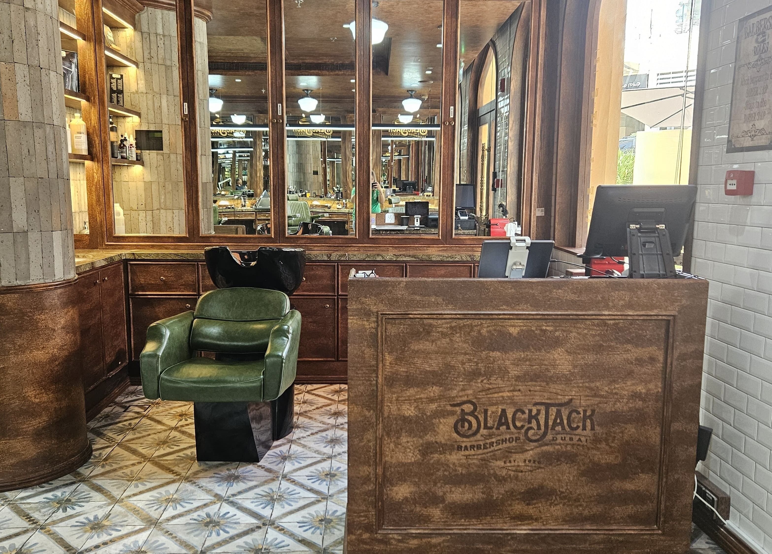 Interior of JBR BlackJack Barbershop in Dubai, Dubai, AE showcasing rustic decor and styling station.