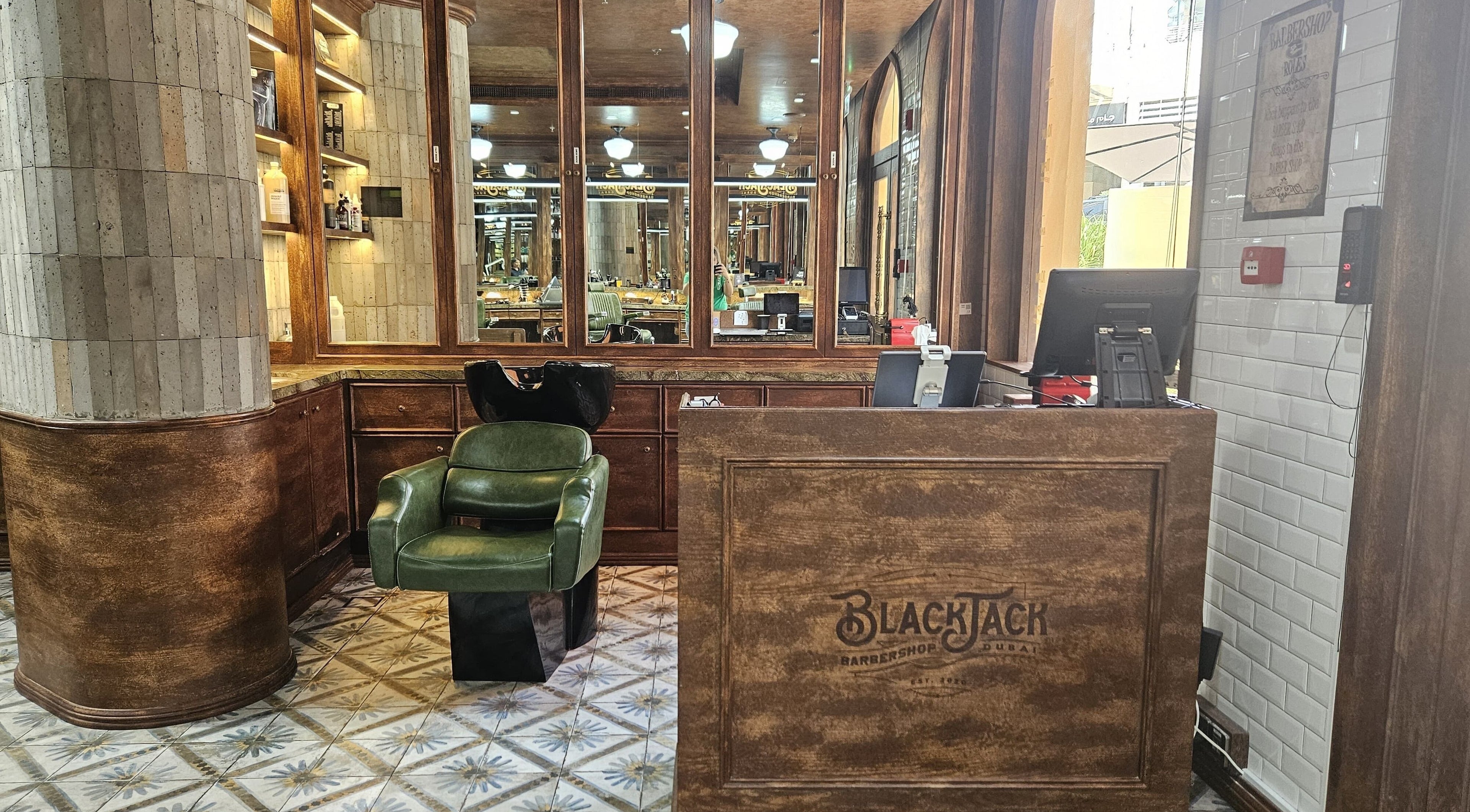 Interior of JBR BlackJack Barbershop in Dubai, Dubai, AE showcasing rustic decor and styling station.