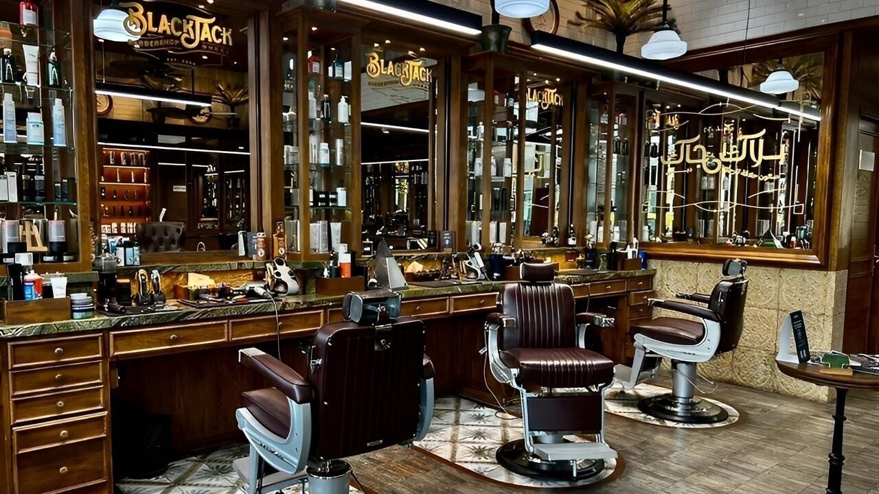 Interior of BLUEWATER BLACK JACK BARBER SHOP in Dubai, AE, featuring classic barber chairs and mirrored shelves.